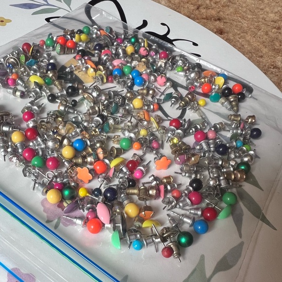 Bag full of different colored stud earrings. - Picture 3 of 13